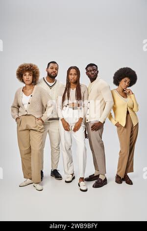 five african american people in casual attire standing on grey background, Juneteenth concept Stock Photo