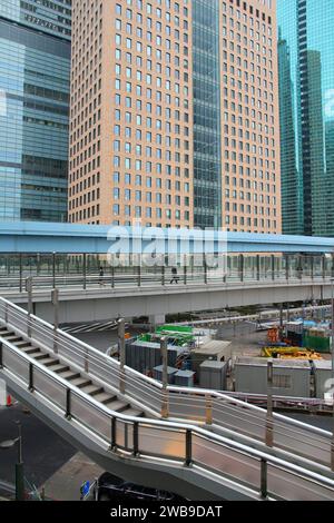 TOKYO, JAPAN - APRIL 13, 2012: People visit Shiodome district in Tokyo. Shiodome is an area of Minato Ward in Tokyo. Stock Photo