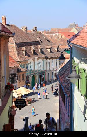 SIBIU, ROMANIA - AUGUST 24, 2012: People visit Old Town in Sibiu, Romania. Sibiu is a major tourism destination in Transylvania. Stock Photo