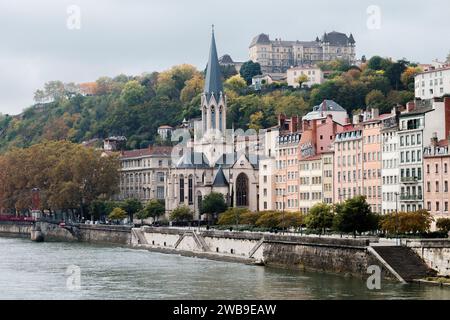 Cityscape of the French city Lyon, with the Saône river in the front and the Saint Georges church surrounded by buildings and trees Stock Photo