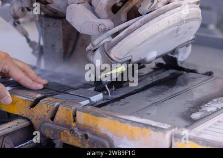 Ceramic tile cutter tiler using diamond blade saw machine Stock Photo