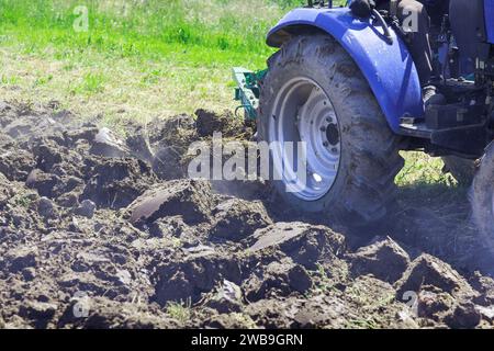 Tractor ploughs land in autumn in preparation for spring planting farming Stock Photo