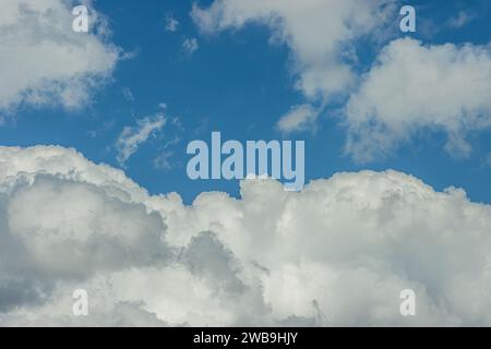 Clouds in the blue sky at day. Sunny moment with summer clouds. Background and textures for a cloudy sky. Cloud formation in the atmosphere Stock Photo