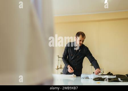 Leather sewing machine in action in a workshop with hands working on a  shoulder bag Stock Photo - Alamy