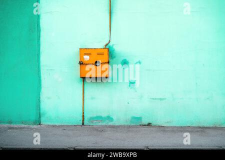 Old gas meter box on green wall with copy space Stock Photo