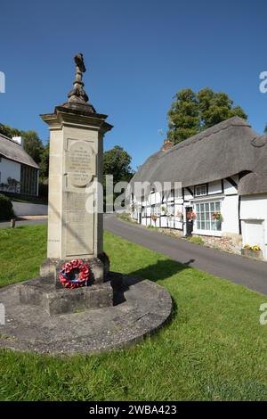 Thatched cottages and war memorial on the village green, Wherwell, Test Valley, Hampshire, England, United Kingdom, Europe Stock Photo