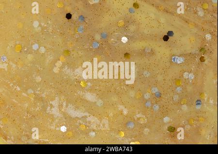 Glitter yellow slime surface macro close up view Stock Photo