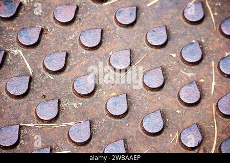 Brown metal lid with molded elements in the form of droplets on it Stock Photo