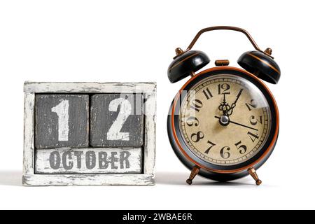 October 12 on wooden calendar with alarm clock white background Stock Photo
