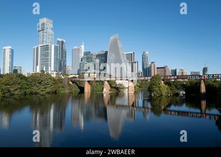 Austin Texas downtown skyline with Railroad Bridge crossing Ladybird Lake aka Colorado River and Town Lake. Stock Photo