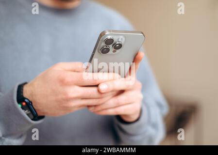 holding cellphone in hands. texting message, scrolling Stock Photo