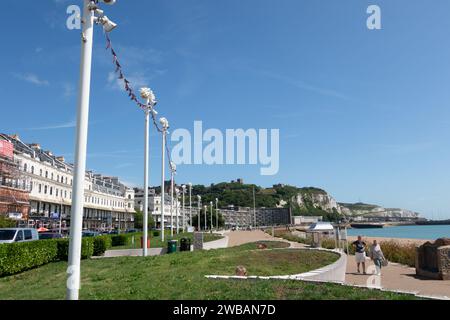 Dover sea front beach and promenade with castle above. Kent England Stock Photo