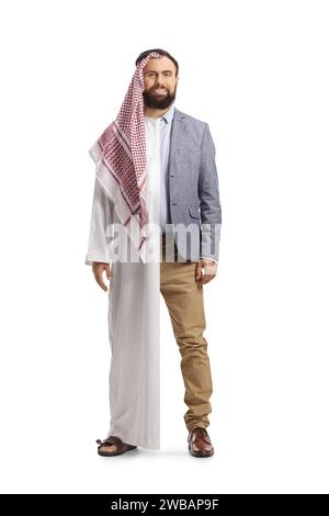 Full length portrait of a saudi arab man wearing a traditional robe and casual work clothes isolated on white background Stock Photo