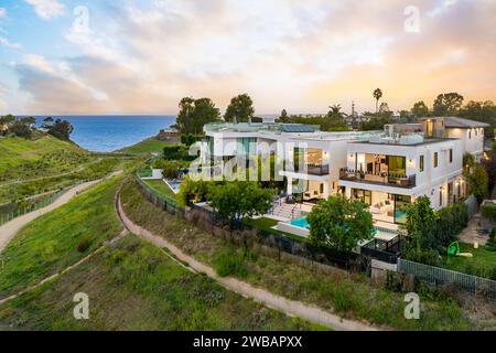 Aerial view of beachfront property, illuminated by the setting sun Stock Photo