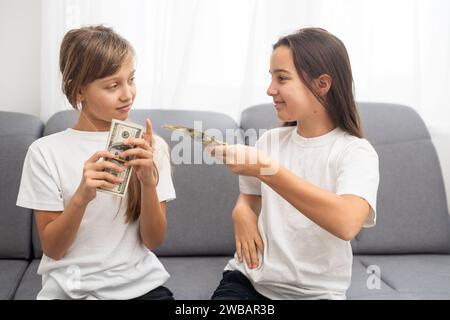 Photo of lucky caucasian girls wearing casual clothing holding fans of dollars in hands  Stock Photo