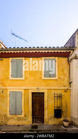 Arles, France, Sept 9th 2023, view of a yellow wall house with closed shutters in Grand Couvent Street Stock Photo