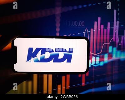 Konskie, Poland - January 07, 2024: KDDI company logo displayed on mobile phone screen Stock Photo