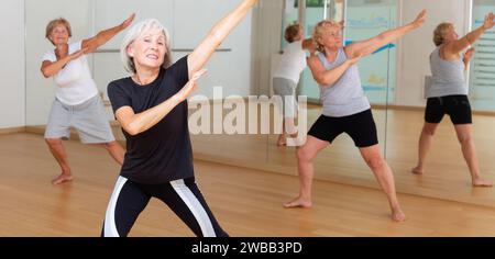 Active mature woman learning dynamic dances in choreography class Stock Photo