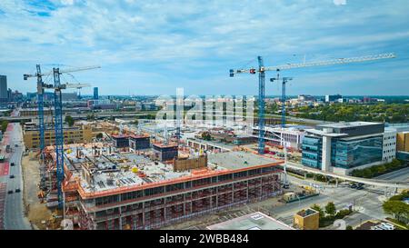 aerial view of construction site with cranes and high-rise apartment ...