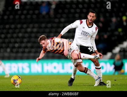 Derby County's Curtis Nelson (right) and Bradford City's Bobby Pointon battle for the ball during the Bristol City Motors Trophy round of 16 match at Pride Park, Derby. Picture date: Tuesday January 9, 2024. Stock Photo