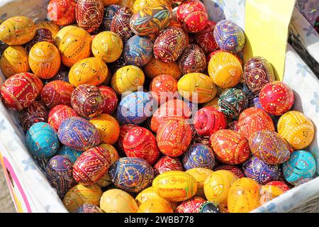 Traditional Czech easter eggs for sale at a market. Hand painted Easter eggs at a basket. Stock Photo
