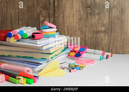 Many different books, paper plane and school stationery on white table, space for text. Back to school Stock Photo