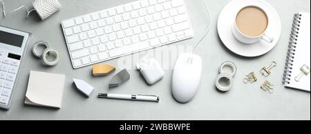 Flat lay composition with wired computer mouse and stationery on light grey table. Space for text Stock Photo