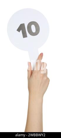 Woman holding auction paddle with number 10 on white background, closeup Stock Photo