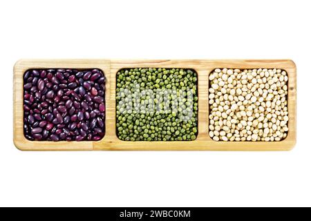 Green mung bean lentils, ruby haricot and soybeans in wooden menagerie isolated on white background Stock Photo