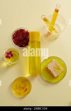 Mockup scene for cosmetic with natural ingredient, saffron extract and honey in petri dishes on beige background. A bottle unbranded for design packag Stock Photo