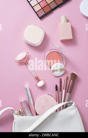 Trendy pink makeup tools on pink background: makeup brushes, eye-shadows, blush. Concept of different female accessories. Female everyday cosmetics Stock Photo