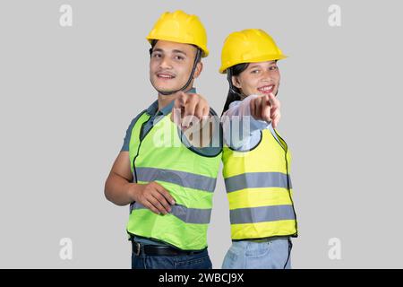 Asian Couple Engineer and Architect giving gestures and expressions on construction field Stock Photo