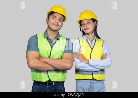 Asian Couple Engineer and Architect giving gestures and expressions on construction field Stock Photo