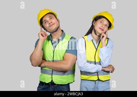 Asian Couple Engineer and Architect giving gestures and expressions on construction field Stock Photo