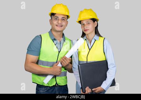 Asian Couple Engineer and Architect giving gestures and expressions on construction field Stock Photo