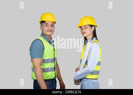 Asian Couple Engineer and Architect giving gestures and expressions on construction field Stock Photo