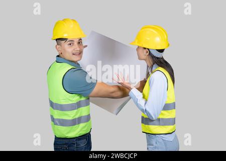 Asian Couple Engineer and Architect giving gestures and expressions on construction field Stock Photo