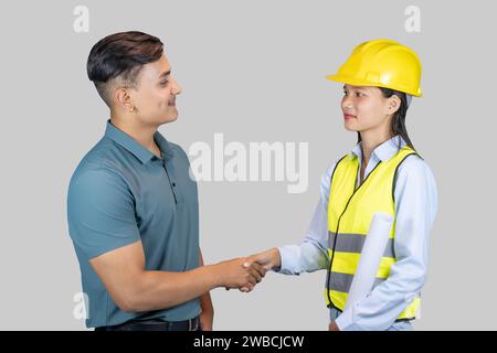 Asian Couple Engineer and Architect giving gestures and expressions on construction field Stock Photo