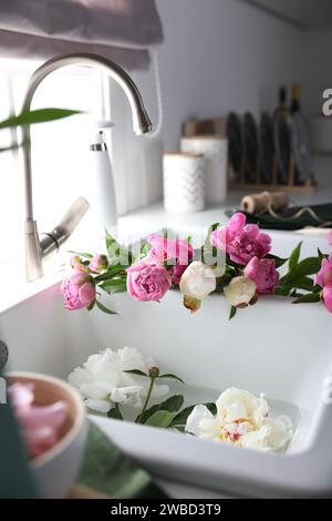 Bunch of beautiful peonies in kitchen sink Stock Photo - Alamy
