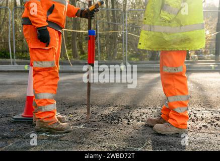 Site engineer surveyor and site manager discussing plan of works on construction site during new road construction Stock Photo