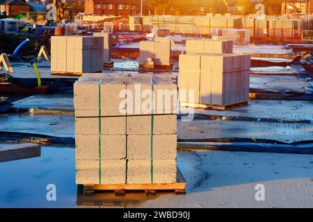Bricks and concrete blocks delivered to construction site and placed next to the place of work and ready for bricklayers Stock Photo