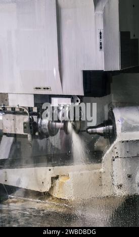 operator machining automotive parts by high precision machining center Drilling machine workpiece CNC drilling machine working process on metal factor Stock Photo