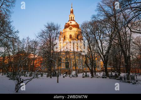 First sunrays on the Katarina Church in Stockholm, Sweden, winter landscape, clear blue sky. Peaceful cementary area. Stock Photo
