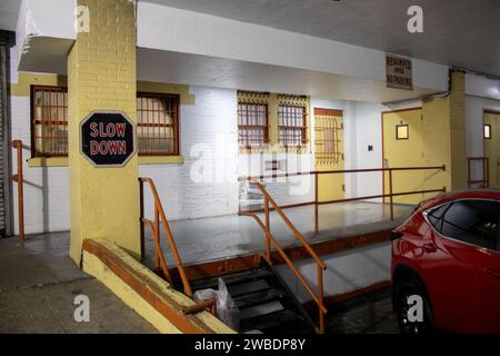 A modern red car parked in the interior of a multi-story parking garage Stock Photo