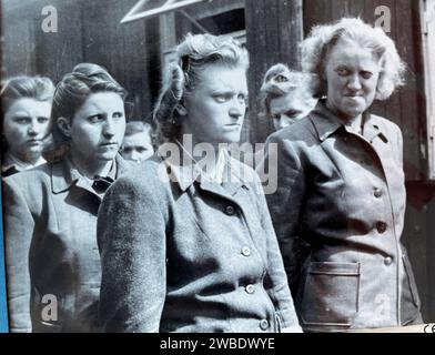 BERGEN-BELSEN CONCENTRATION CAMP, Germany. Female guards are paraded after the camp was liberated by British troops 15 April 1945. Stock Photo