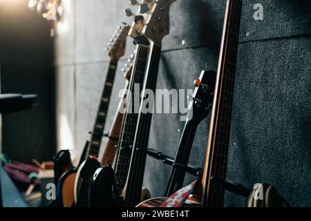 Music instruments in room. Guitars stay in row. Sound recording studio background. Stock Photo