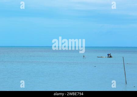 Fisherman is fishing alone in the northern province of Sri Lanka in the Jaffna district with a beautiful coastal view Stock Photo