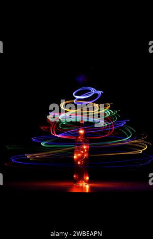 Light in a bottle with light swirl around Stock Photo