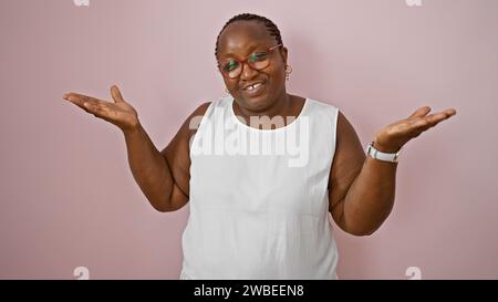 Clueless african american woman, standing over a pink isolated background, uncertain expression making a silent question. Stock Photo