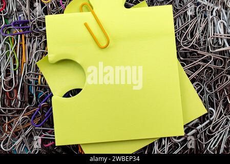 Background from multi-colored paper clips. Office tools. Paper form with empty space for inscription Stock Photo